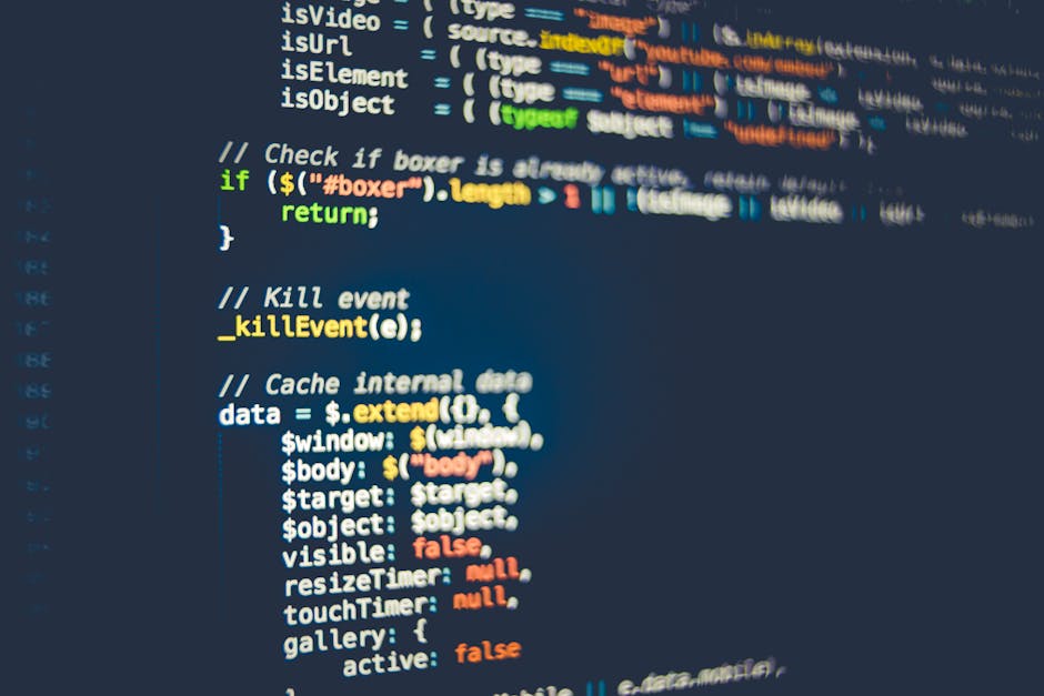 A close-up image of a computer screen displaying lines of code in a text editor, with syntax highlighting showing keywords and symbols in various colors including green, blue, purple, and red. The lef